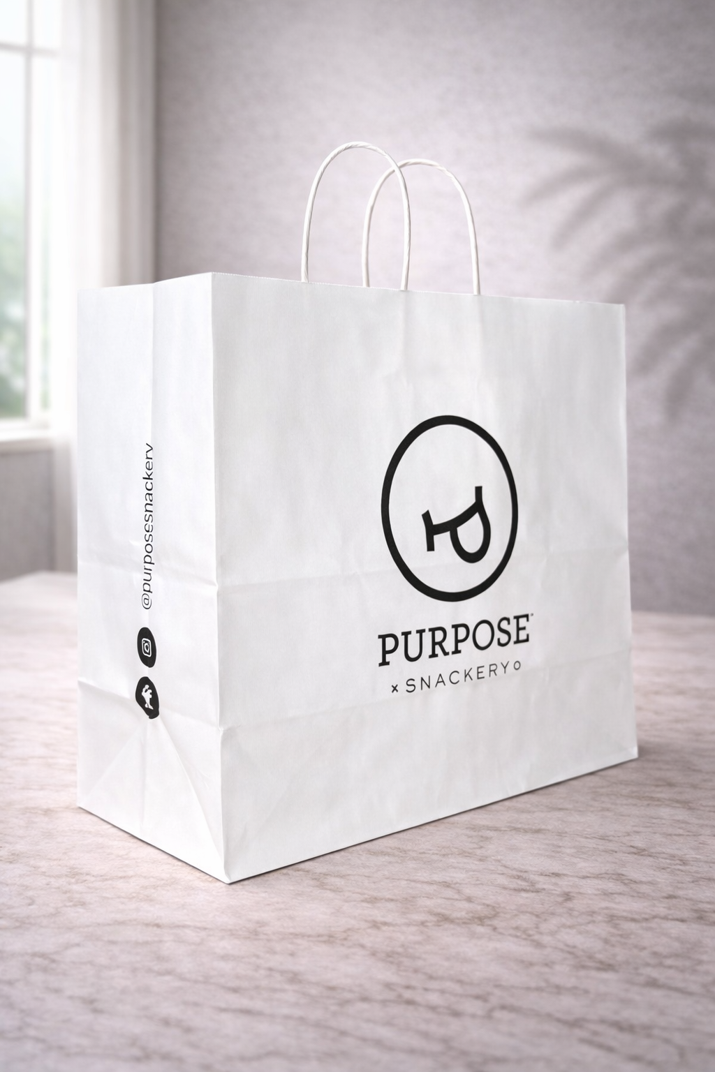 Extra-large white twisted handle paper bag with Purpose Snackery branding