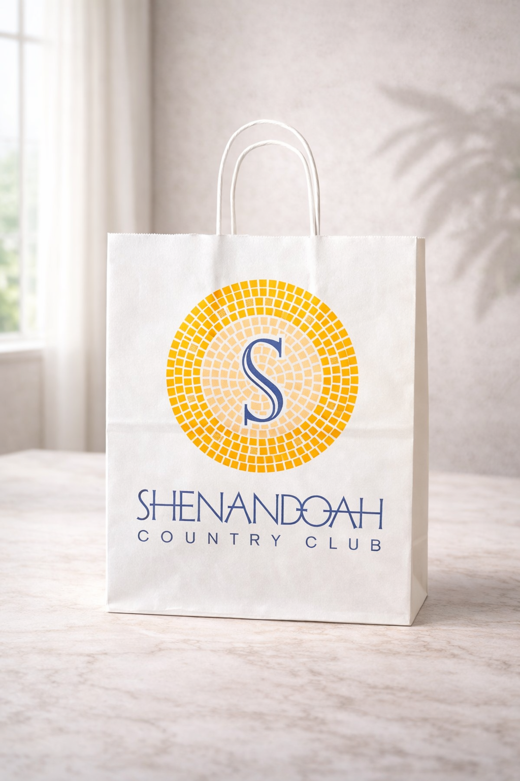 Medium white twisted handle paper bag with Shenandoah Country Club branding